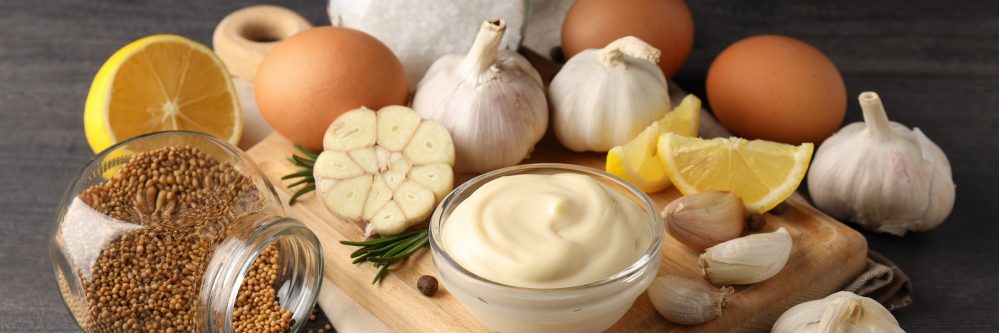Concept of cooking garlic sauce on wooden background